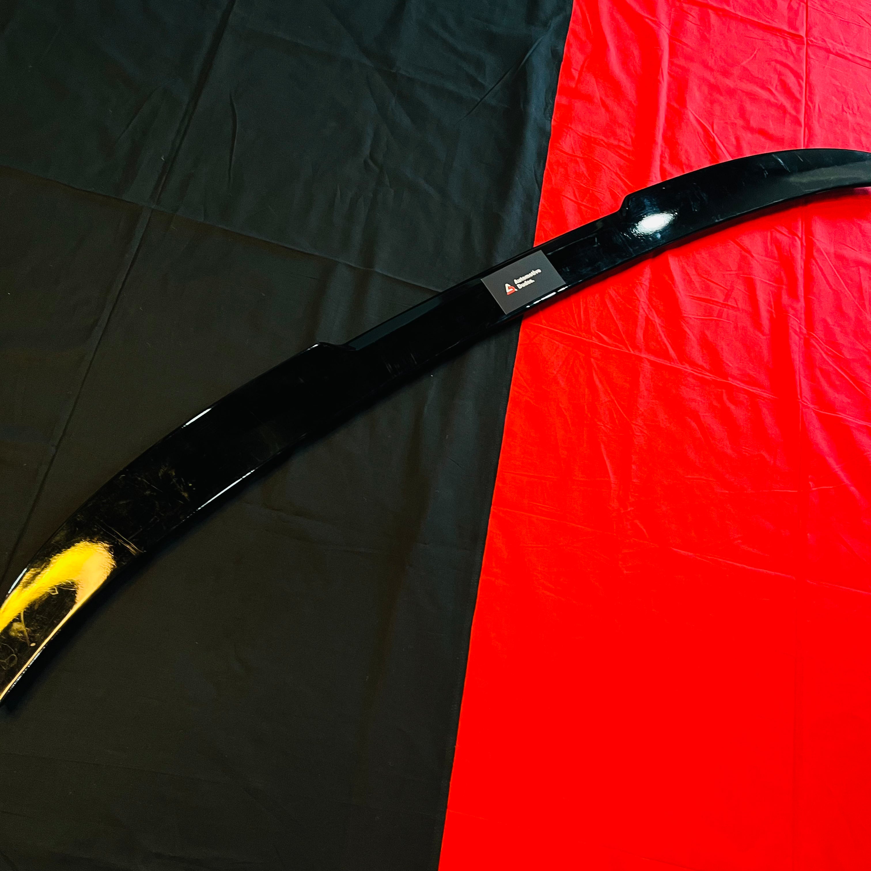 Black car bumper on a black and red checkered background